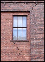 cracked brick masonry near a window